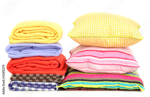 Photo: Bright pillows and plaids, isolated on white Bright pillows and plaids, isolated on white