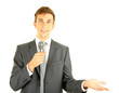 Young businessman talking with microphone, isolated on white