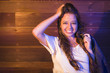 Foto: Mixed Race Young Adult Woman Portrait Against Wooden Wall Mixed Race Young Adult Woman Portrait Against Wooden Wall