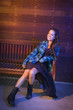 Foto: Mixed Race Young Adult Woman Portrait Sitting on Wood Bench Mixed Race Young Adult Woman Portrait Sitting on Wood Bench