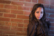 Foto: Pretty Mixed Race Young Adult Woman Against a Brick Wall Pretty Mixed Race Young Adult Woman Against a Brick Wall