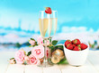 Romantic still life with champagne, strawberry and pink roses,