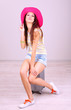 Beautiful girl with suitcase in room