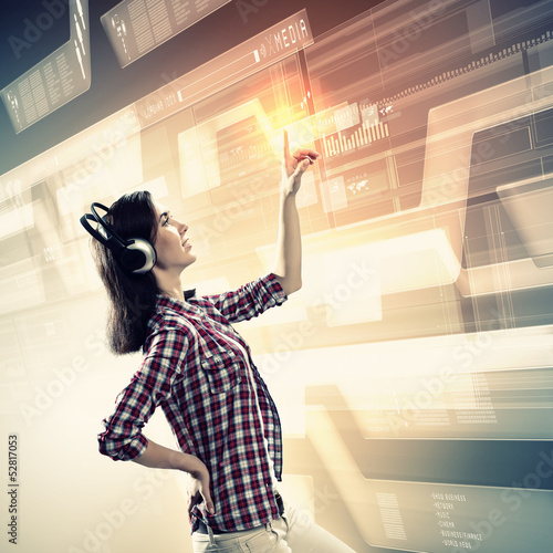 Photo: Woman touching virtual screen Woman touching virtual screen