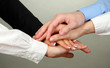 Group of young people's hands on gray background