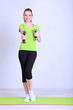Beautiful young woman exercises with dumbbell