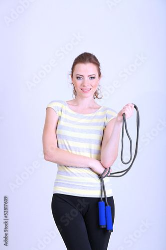 Photo: Beautiful young woman with skipping rope Beautiful young woman with skipping rope
