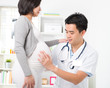 asian medical male doctor performing pregnancy check up