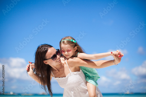 Photo: Young beautiful mother and her adorable little daughter at Young beautiful mother and her adorable little daughter at