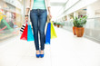 Shopping time, women legs at mall