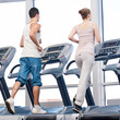 Woman and man at the gym exercising.