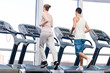 Woman and man at the gym exercising.