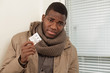 Sick man with flu holding pills