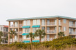 Stucco Condo with Green Roof and Awnings