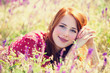 Redhead girl at green grass at village outdoor