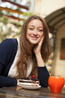 Style girl with cake and cup sitting in the cafe