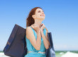 Redhead teen girl with shopping bags on the beach
