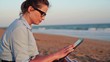 Video: Businesswoman working on tablet computer on the beach Businesswoman working on tablet computer on the beach
