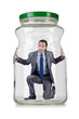 Young businessman in glass jar