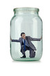 Young businessman in glass jar