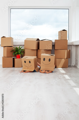 Photo: Kids having fun while moving in a new home Kids having fun while moving in a new home