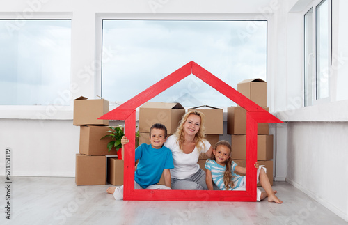 Photo: New home concept with woman and kids New home concept with woman and kids