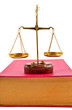 Scales of justice atop books