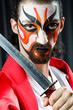 Man with sword and face mask