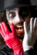 Joker personification with man in dark room