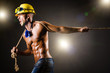 Foto: Nude builder pulling rope in darkness Nude builder pulling rope in darkness