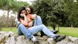 Boyfriend hugging and kissing girlfriend in park
