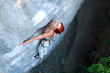 Photo: A man climbs a wall. A man climbs a wall.