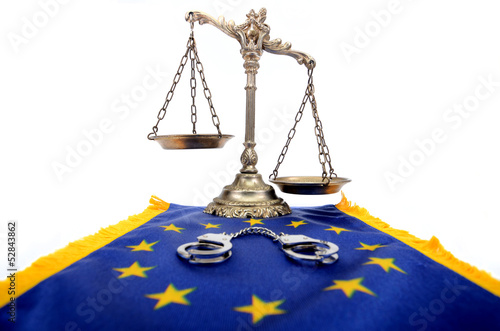 Photo: Scales of Justice , handcuffs and European Union flag Scales of Justice , handcuffs and European Union flag