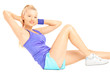 Photo: Blond female exercising abs on floor Blond female exercising abs on floor