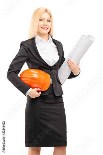 Photo: Female architect in black suit holding a helmet and a blueprint Female architect in black suit holding a helmet and a blueprint