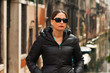 Young brunette woman with sunglasses on bridge in Venice. Italy.