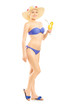 Full length portrait of a woman in bikini holding a cocktail