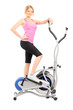 Young woman posing on a cross trainer fitness machine