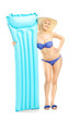 Young woman in bikini holding a swimming mattress
