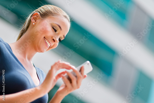 Photo: Business woman using a smart phone Business woman using a smart phone