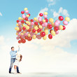 Father and daughter holding balloons