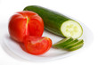Slised tomatoes and cucumber on a white plate