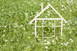 Photo: Wooden home in spring green grass ecological building concept Wooden home in spring green grass ecological building concept