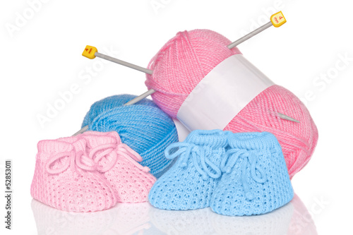 Photo: Baby booties with wool and knitting needles Baby booties with wool and knitting needles