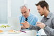 Photo: Business People Working at Lunch Business People Working at Lunch