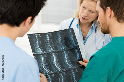 Photo: Doctors Examining X-ray Report Doctors Examining X-ray Report