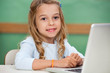 Photo: Girl With Laptop At Classroom Desk Girl With Laptop At Classroom Desk