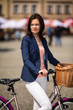 Urban biking - middle-age woman and bike in city