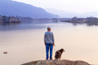 Foto: Old man with the dog at the lake in Killarney National Park Old man with the dog at the lake in Killarney National Park