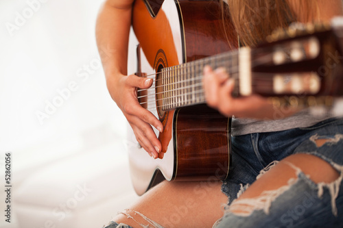 Photo: Closeup image of guitar in woman hands Closeup image of guitar in woman hands